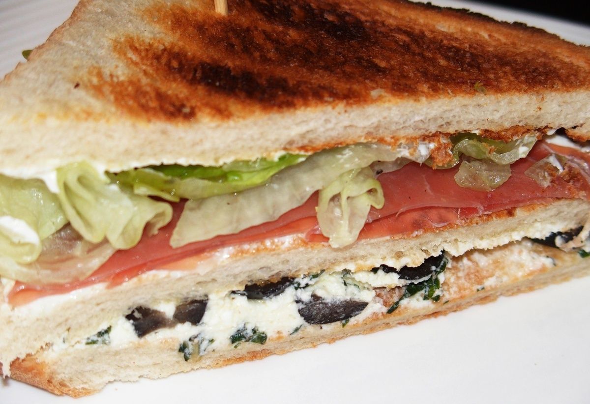 Club sandwich au fromage de chèvre, jambon cru et olives